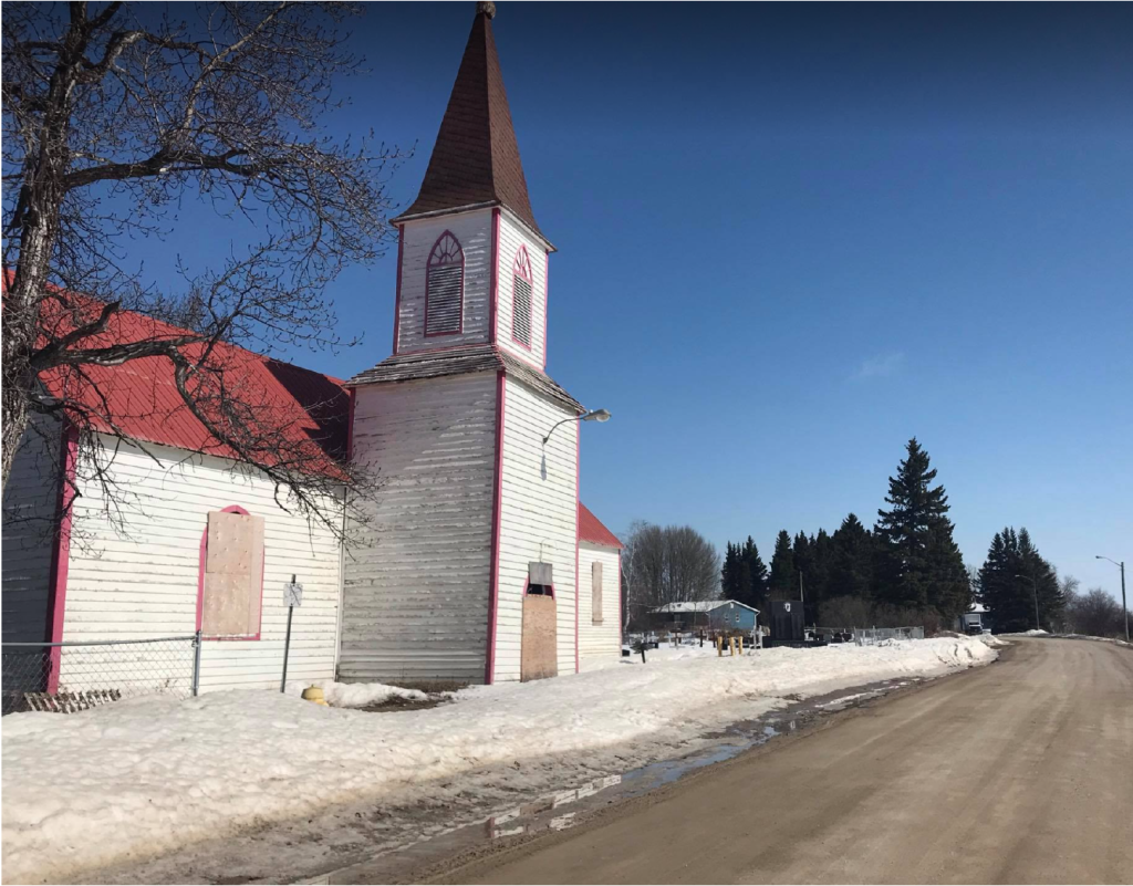 Today St. Thomas Church sits vacant, with wood boards covering the stained glass windows. Photo: Miyopin Cheechoo