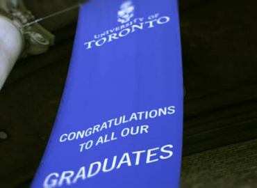 Blue vertical banner hanging at Convocation Hall with the text Congratulations to all our Graduates.